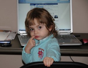Toddler sitting in front of laptop © Tammra McCauley